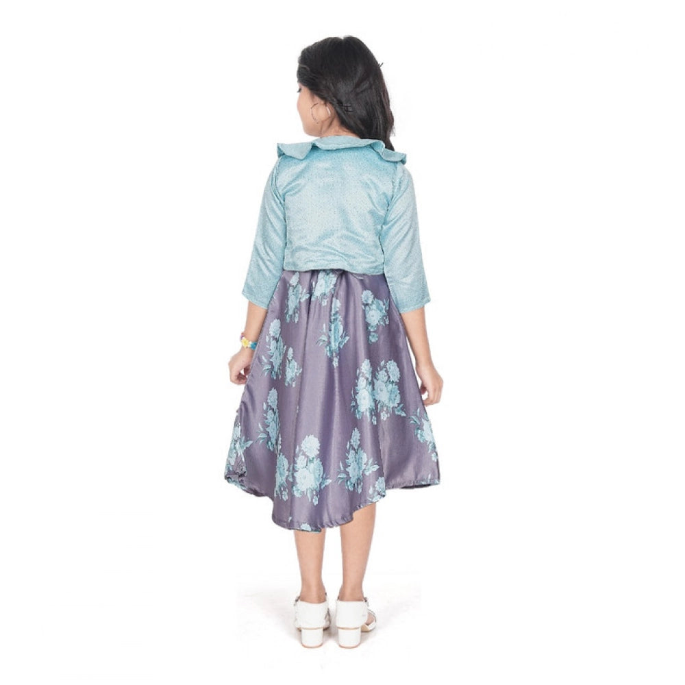 Young girl wearing a blue floral fit and flare dress with a matching 3/4 sleeve shrug and stylish flats