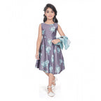 Young girl wearing a blue floral fit and flare dress with a matching 3/4 sleeve shrug and stylish flats