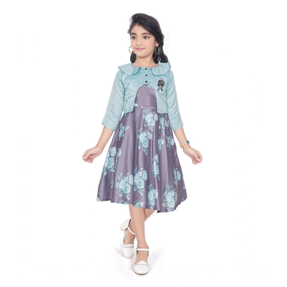Young girl wearing a blue floral fit and flare dress with a matching 3/4 sleeve shrug and stylish flats