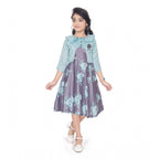 Young girl wearing a blue floral fit and flare dress with a matching 3/4 sleeve shrug and stylish flats