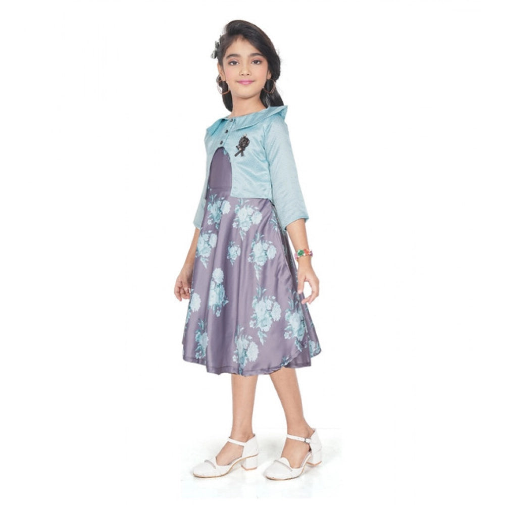 Young girl wearing a blue floral fit and flare dress with a matching 3/4 sleeve shrug and stylish flats