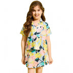 Young girl modeling a premium floral print co-ord set featuring a button-down shirt and matching skirt for casual summer events