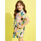 Young girl modeling a premium floral print co-ord set featuring a button-down shirt and matching skirt for casual summer events