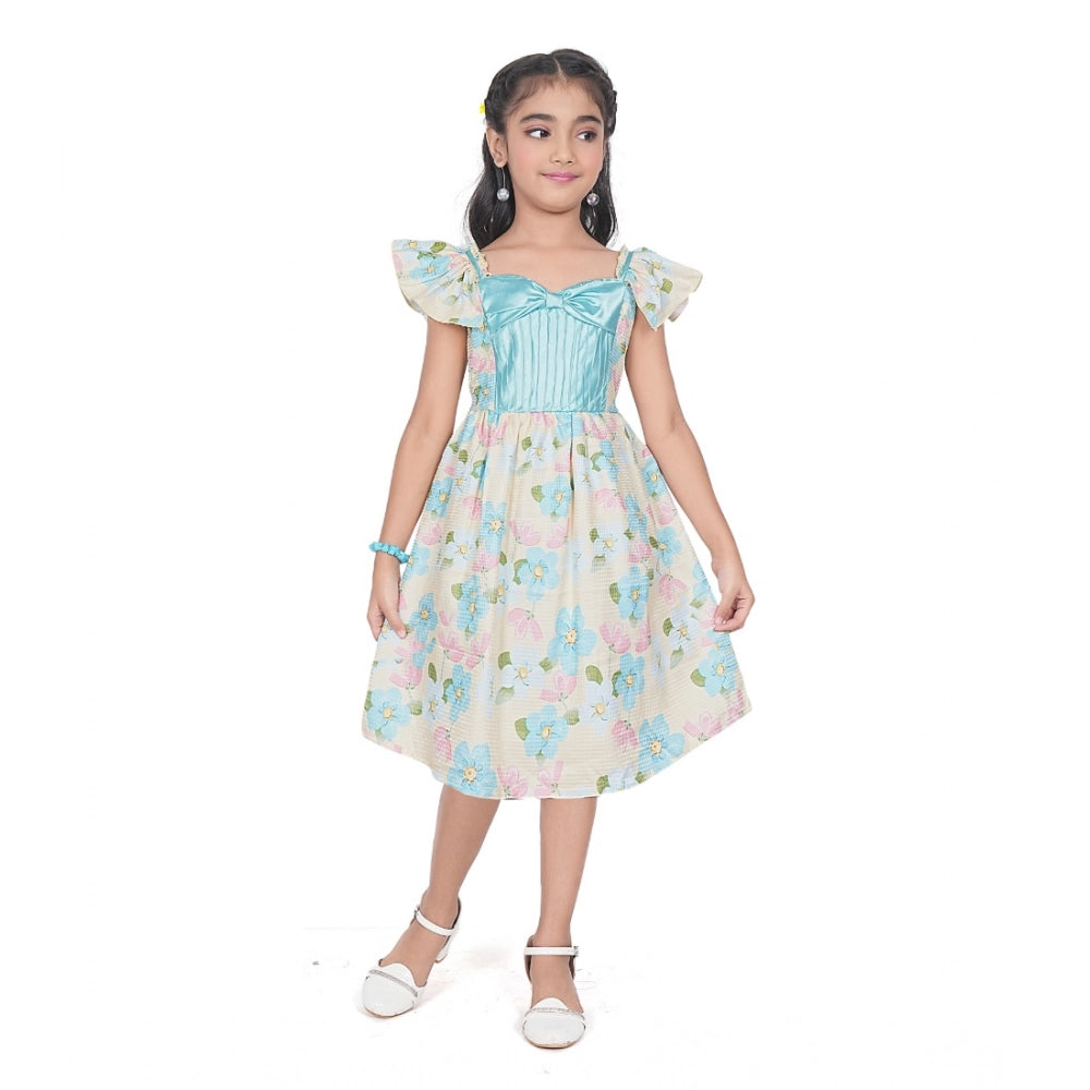 Young girl wearing a premium floral print dress with a satin blue bodice and ruffle sleeves for festive occasions