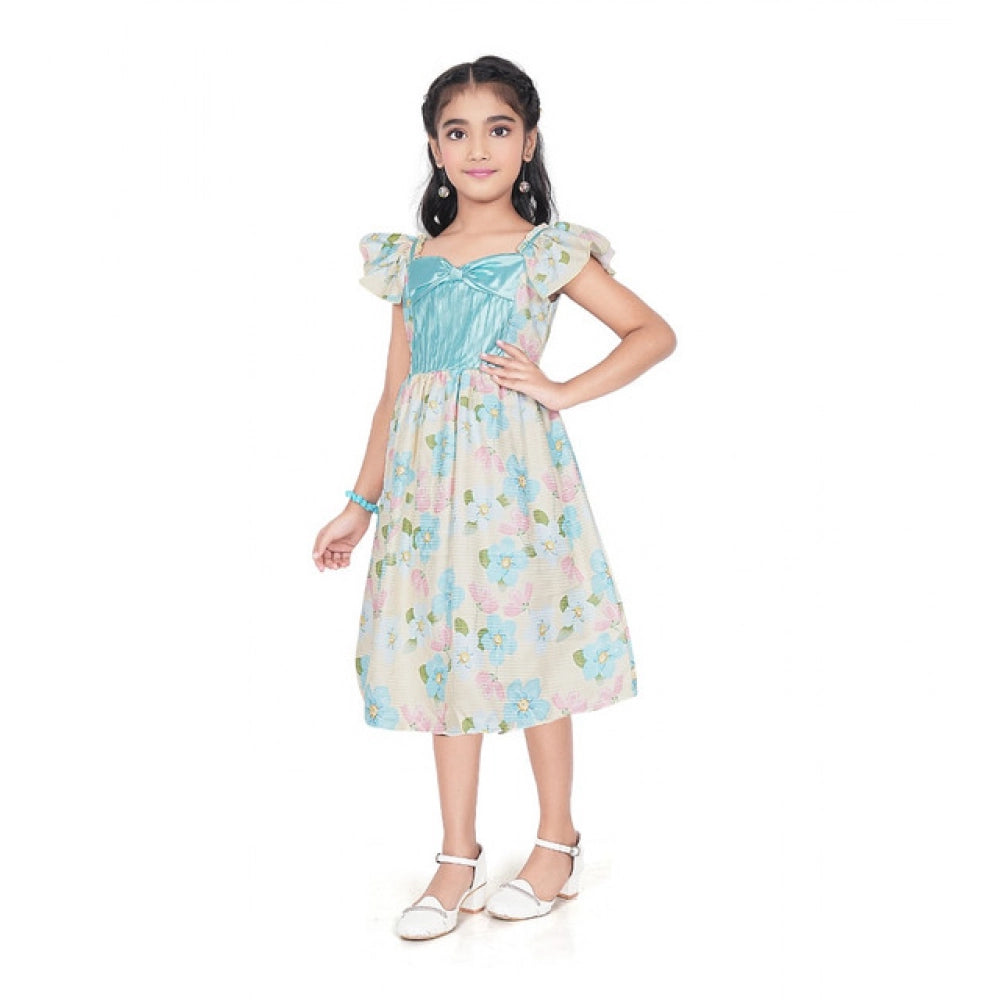 Young girl wearing a premium floral print dress with a satin blue bodice and ruffle sleeves for festive occasions