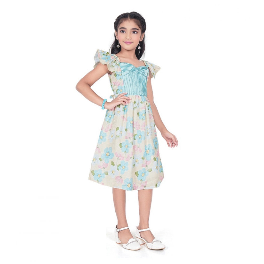 Young girl wearing a premium floral print dress with a satin blue bodice and ruffle sleeves for festive occasions