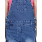 Young girl wearing a blue denim dungaree jumpsuit with pink sleeveless top