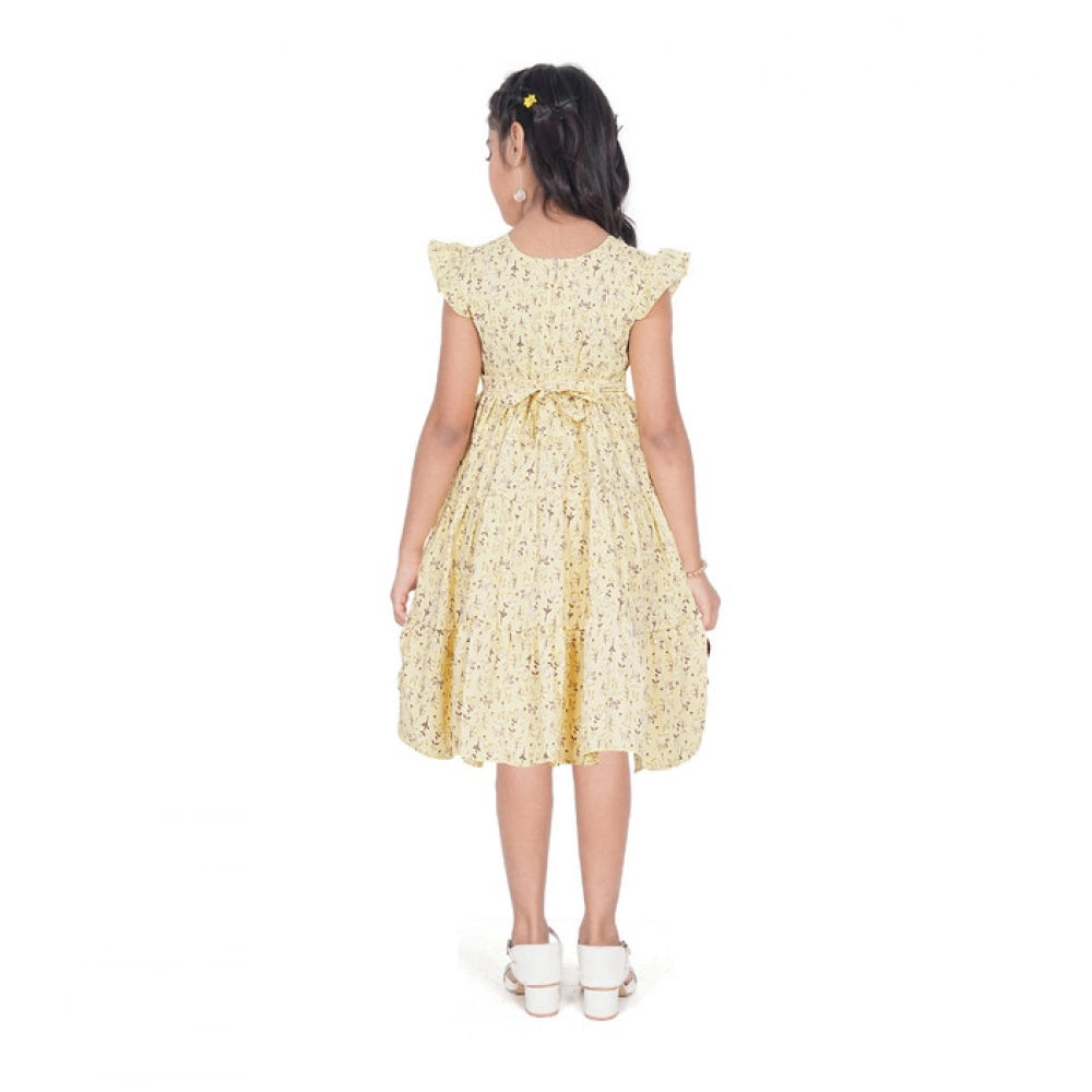 Girl wearing yellow floral party wear dress with cap sleeves
