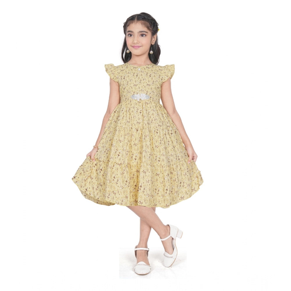 Girl wearing yellow floral party wear dress with cap sleeves