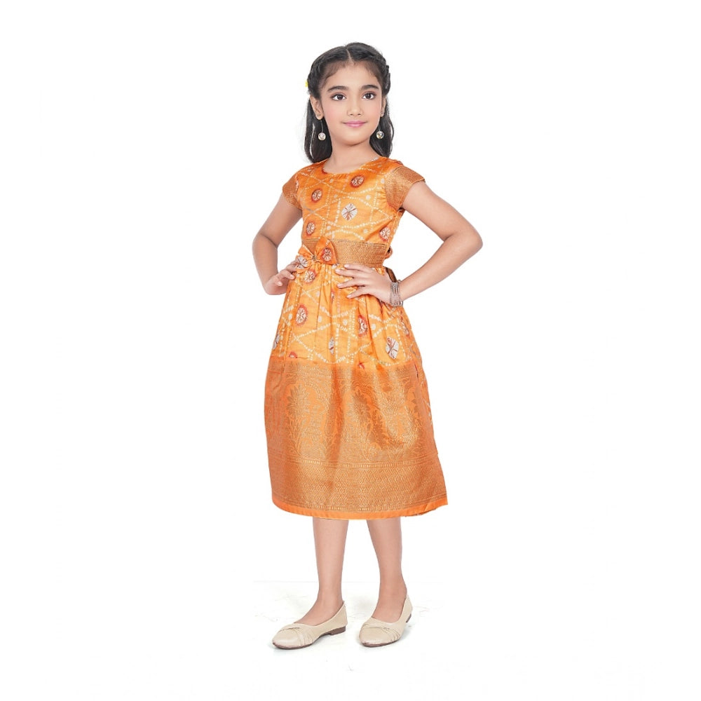 Young girl wearing a premium mustard yellow Banarasi silk frock with traditional woven zari borders, ideal for festive Indian celebrations