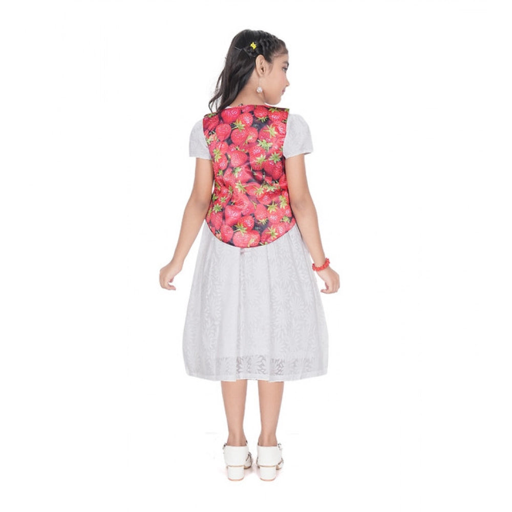 Young girl wearing a premium white eyelet dress layered with a vibrant strawberry print vest, perfect for festive or party wear